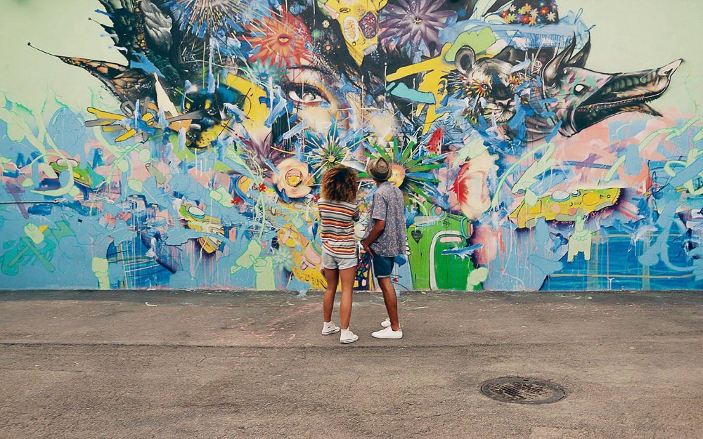 Friends admiring art murals at Wynwood Walls