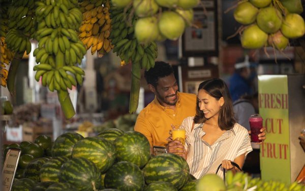 Couple shopping at Robert Is Here fruit stand. 