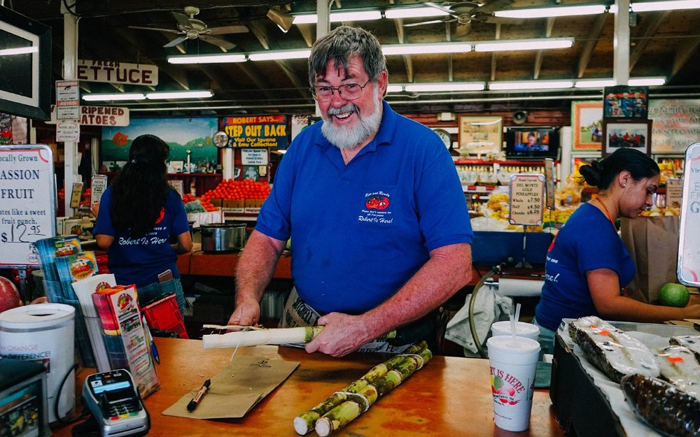 Robert preparing sugarcane at Robert is Here Fruit Stand and Farm