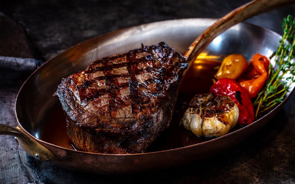 Seared steak and roasted garlic at Bourbon Steak