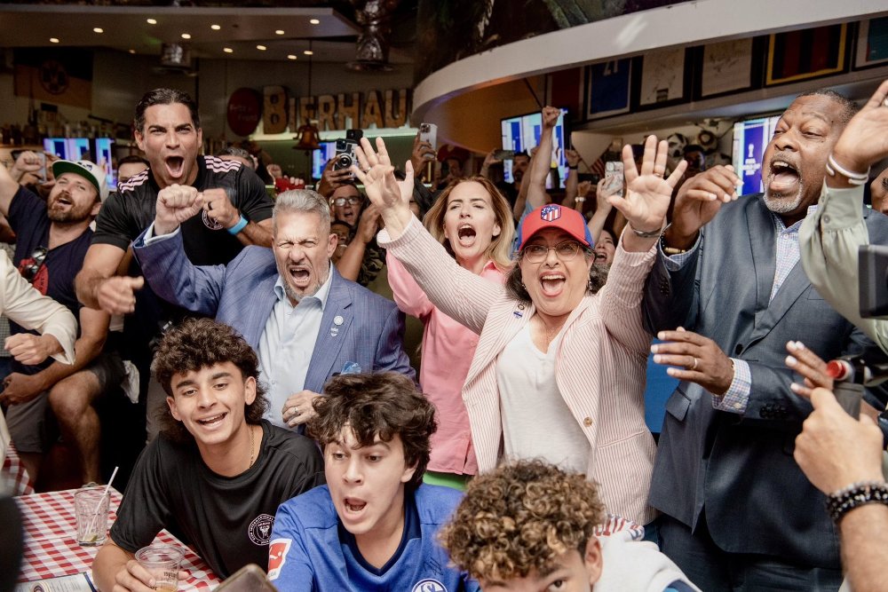 Local officials and fans celebrating FIFA's announcement