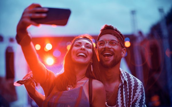 Couple taking selfie at a concert