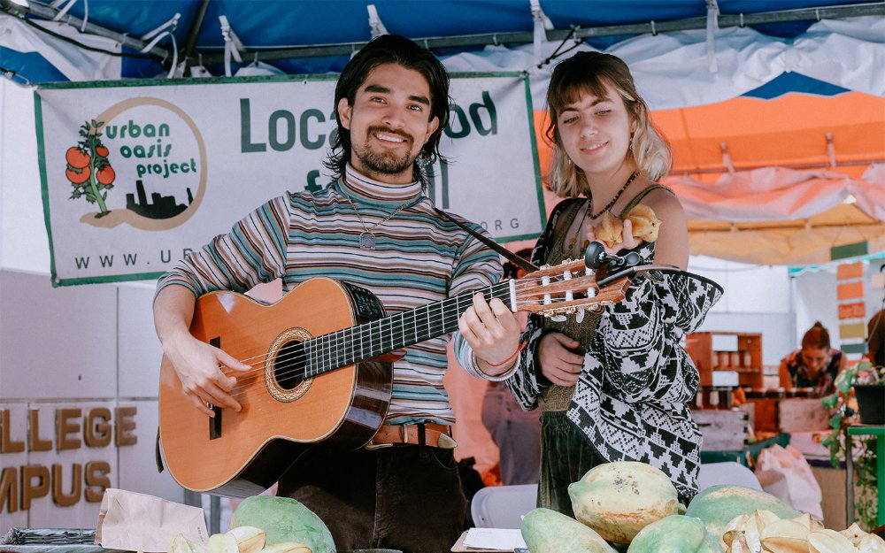 Vendor playing guitar at Miami Book Fair