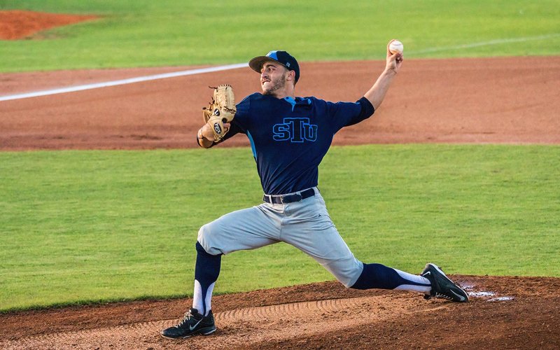 Saint Thomas University pitcher throwing a ball