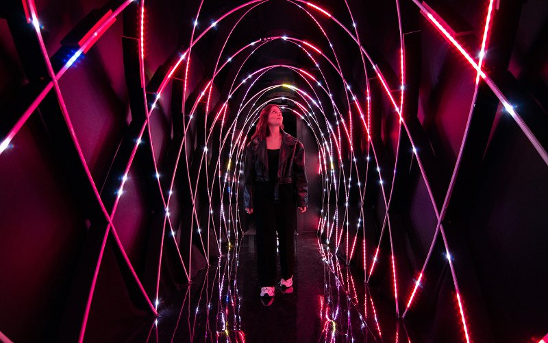 Woman walking through Magentaverse at Artechouse