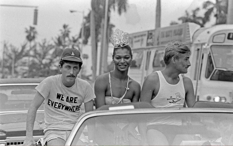 LGBTQ history photo of 3 people supporting gay rights