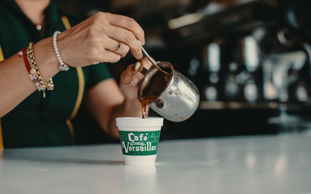 Cuban coffee being poured into a cup at Versailles Restaurant